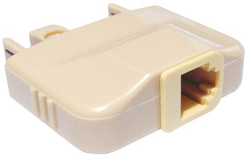 Low angle photo of a telephone plug to modular socket adaptor.