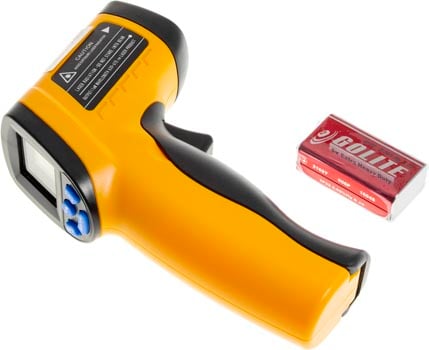 Photo of a non-contact infrared (IR) thermometer and the supplied battery.